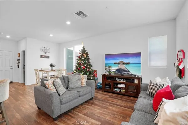 a living room with furniture and a chandelier