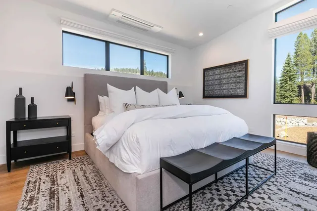 a bedroom with a bed and a table