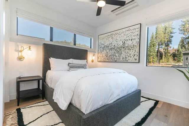 a large bed sitting in a bedroom next to a window