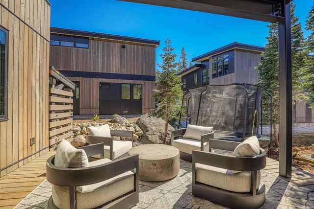 a view of a patio with couches table and chairs and potted plants