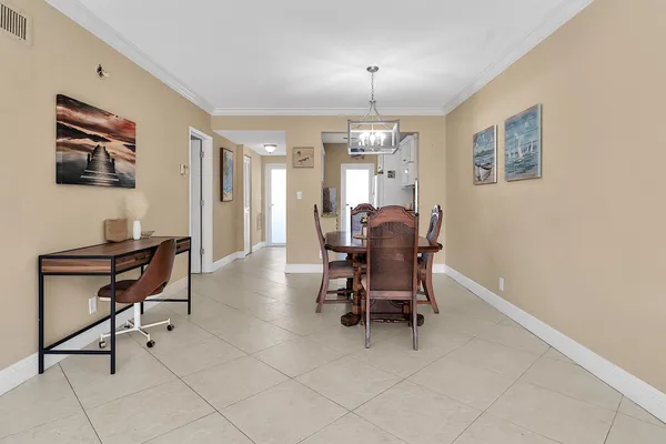 a living room with furniture a chandelier and a flat screen tv