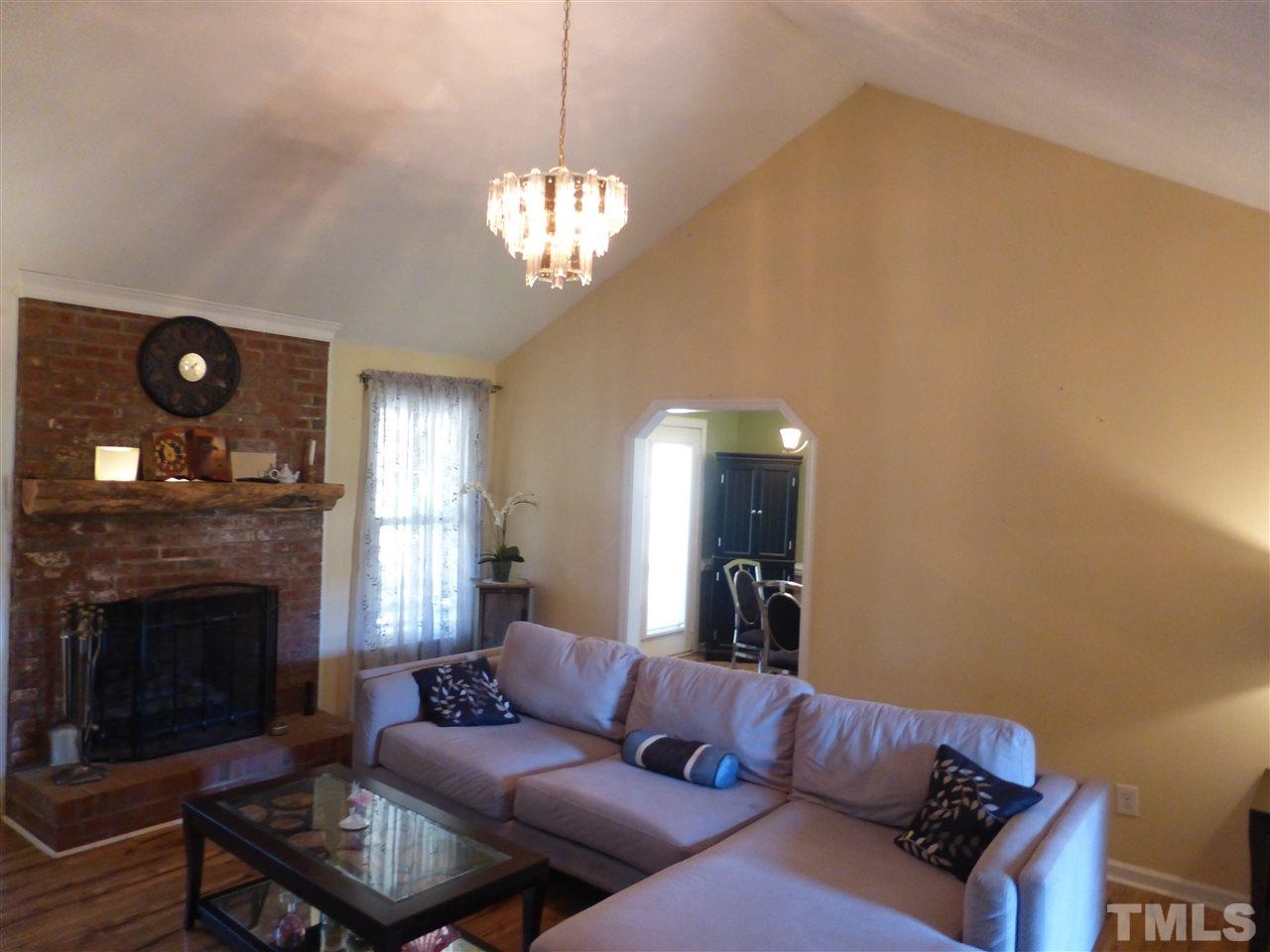 5224 Carrier Way Raleigh, NC 27603 - Photo 8 of 23 a living room with furniture and a fireplace