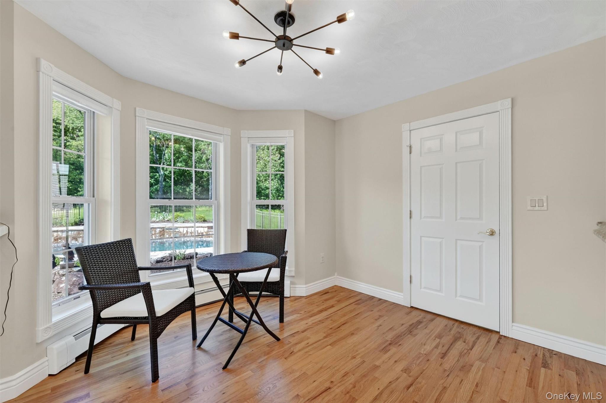 954 Ridgebury Road New Hampton, NY 10958 - Photo 17 of 45 A cozy dining nook overlooks the pool and garden area, creating a lovely spot for morning coffee, casual meals, or quiet conversation.