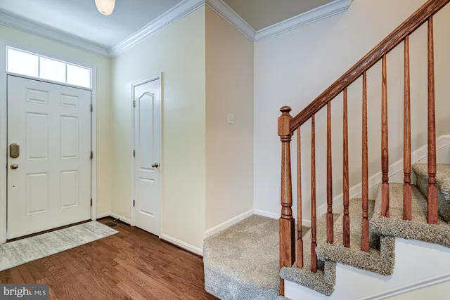 a view of an entryway with wooden floor and door