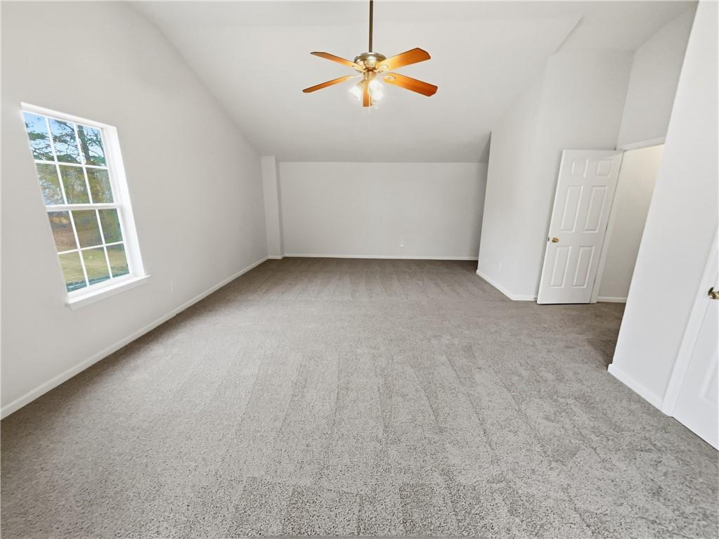 836 Tara Bend Hampton, GA 30228 - Photo 12 of 25 wooden floor in an empty room with a window