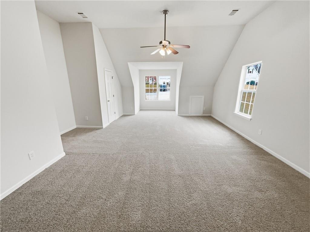 836 Tara Bend Hampton, GA 30228 - Photo 13 of 25 en empty room with windows and ceiling fan