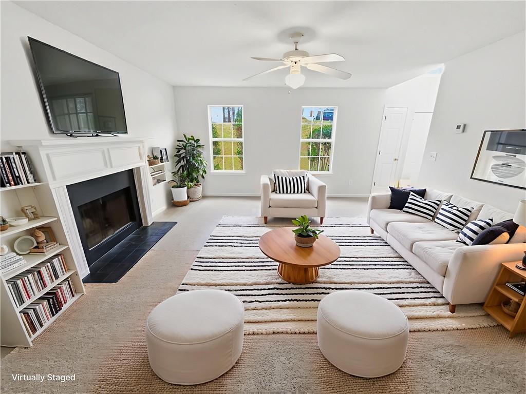 836 Tara Bend Hampton, GA 30228 - Photo 4 of 25 a living room with furniture a fireplace and a flat screen tv