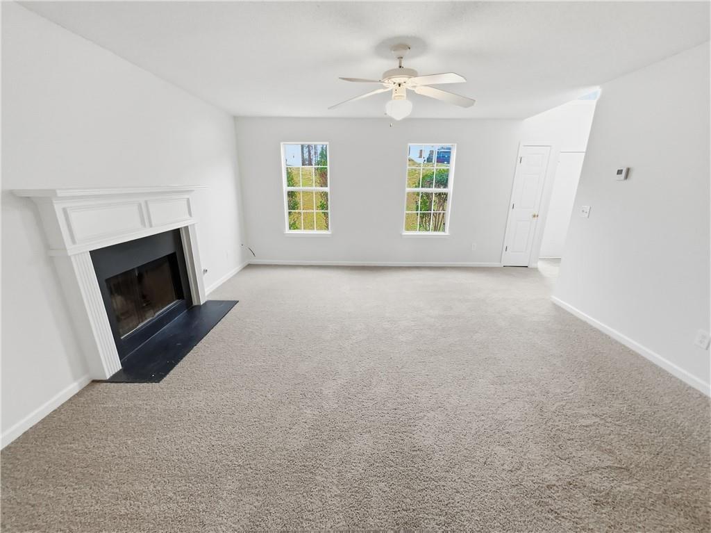 836 Tara Bend Hampton, GA 30228 - Photo 5 of 25 an empty room with windows and fireplace