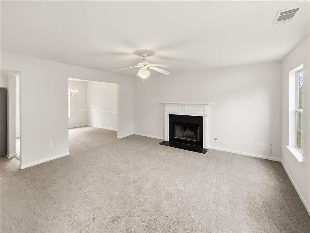 836 Tara Bend Hampton, GA 30228 - Photo 6 of 25 an empty room with windows and fireplace