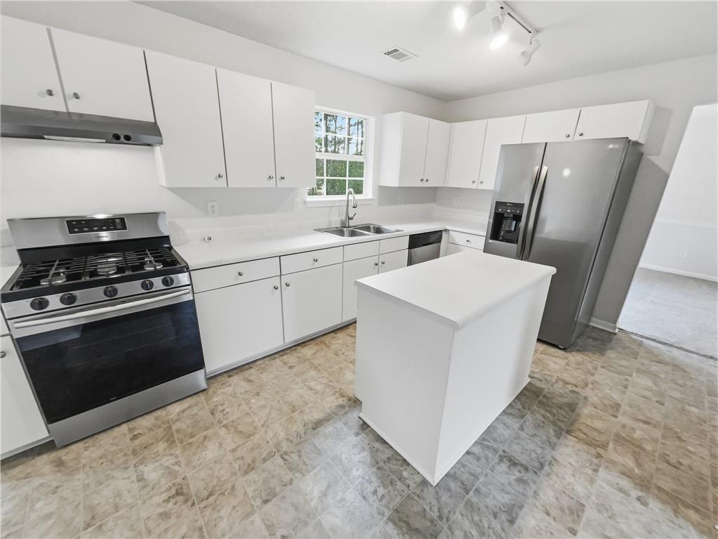 836 Tara Bend Hampton, GA 30228 - Photo 7 of 25 a kitchen with cabinets and stainless steel appliances