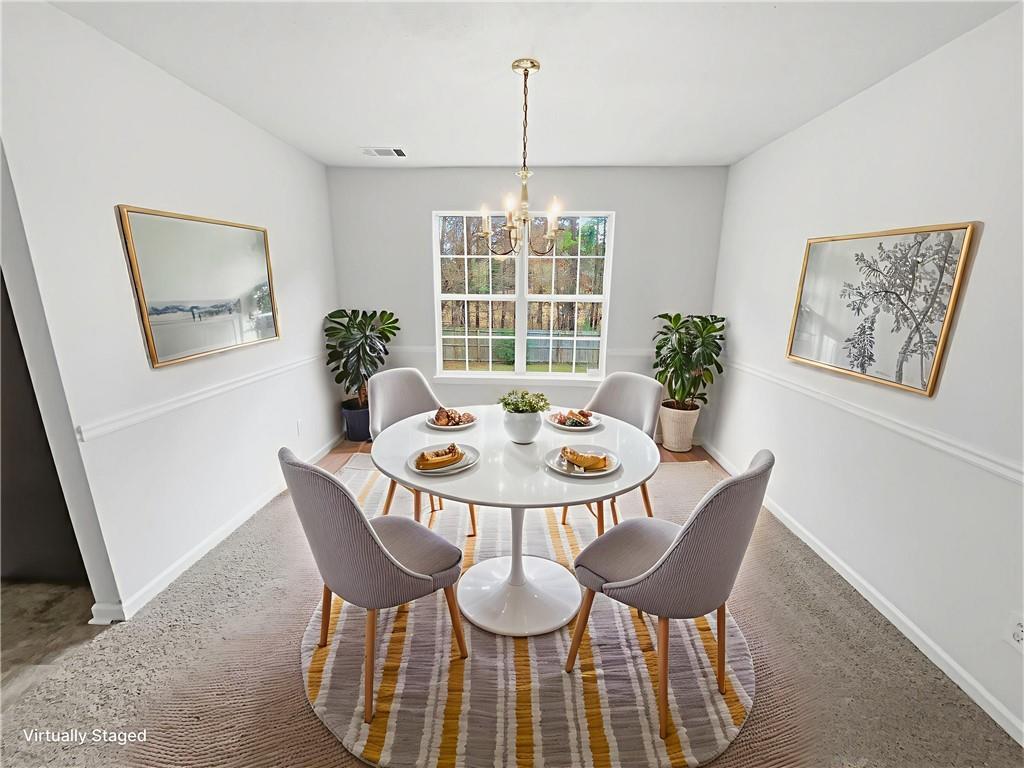 836 Tara Bend Hampton, GA 30228 - Photo 9 of 25 a view of a dining room with furniture window and wooden floor