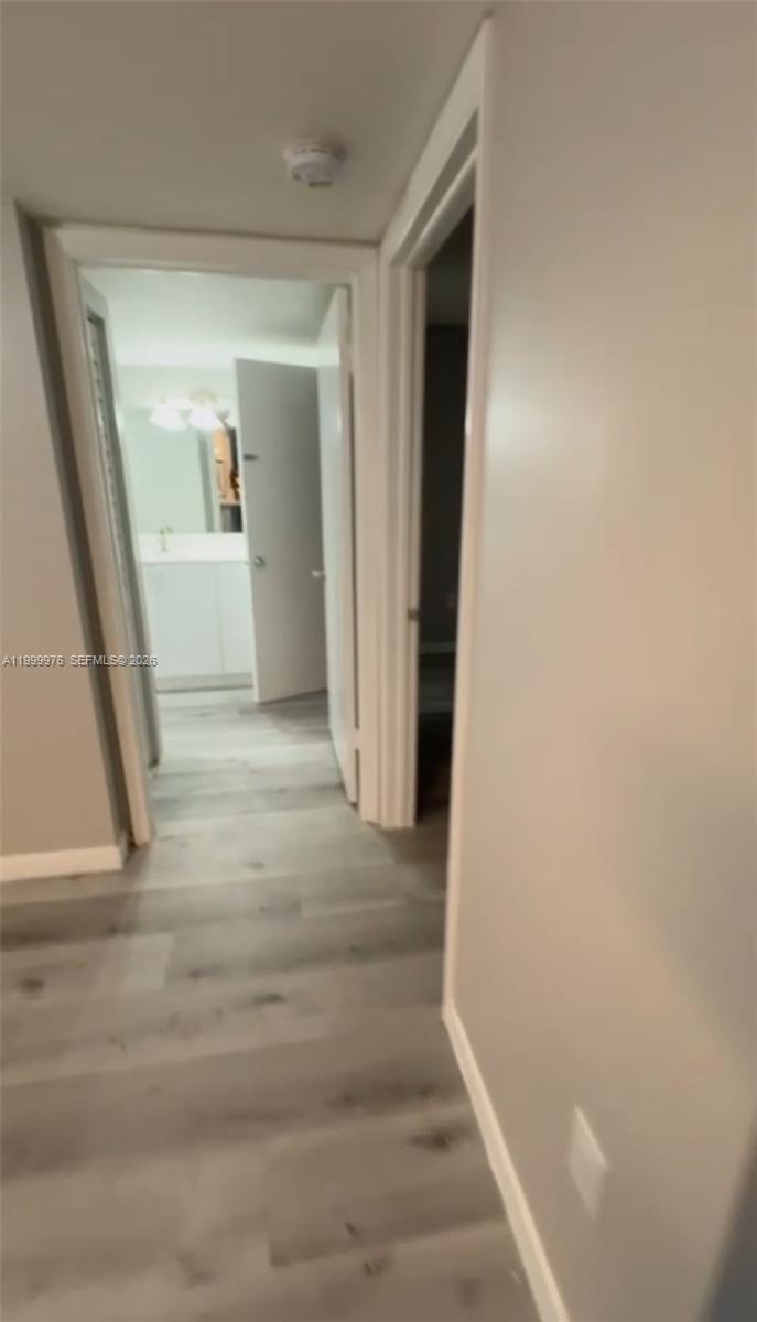 7100 Northwest 179th Street, Unit 102 Hialeah, FL 33015 - Photo 3 of 7 a view of hallway with front door