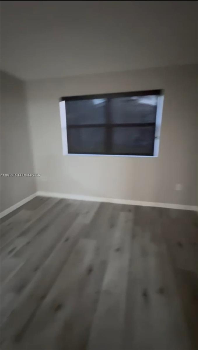 7100 Northwest 179th Street, Unit 102 Hialeah, FL 33015 - Photo 4 of 7 a view of wooden floor