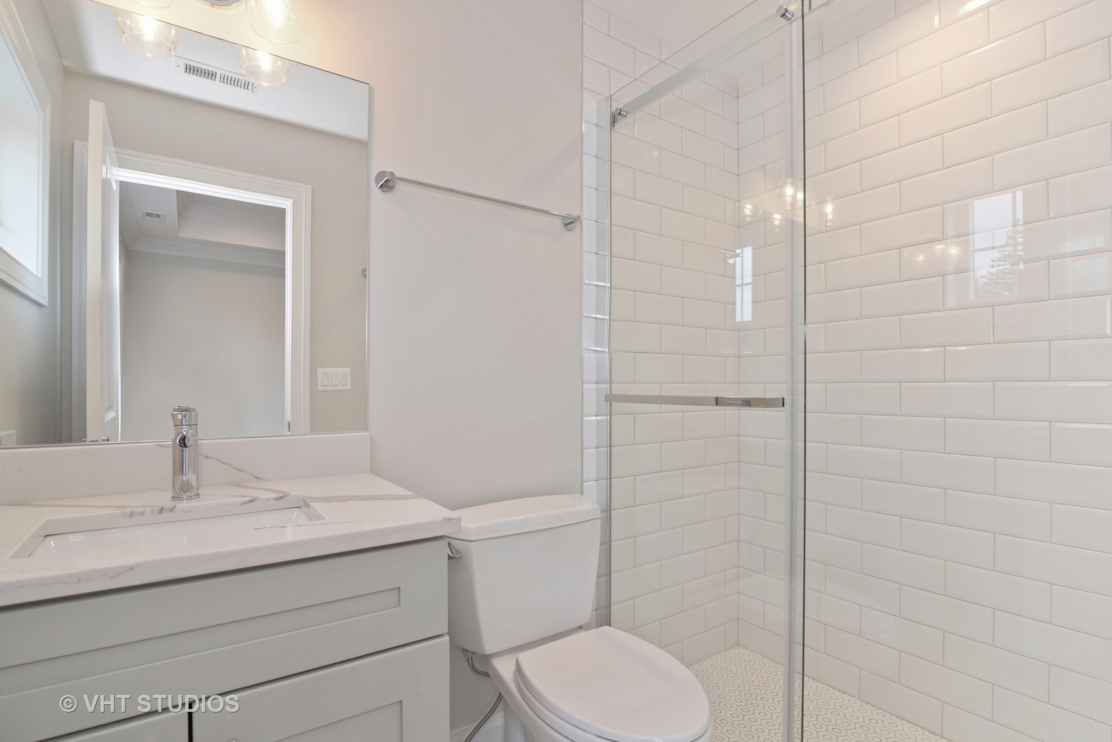 2424 Illinois Road Northbrook, IL 60062 - Photo 11 of 14 a bathroom with a sink toilet and shower