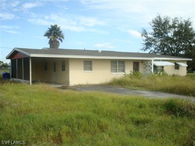 a front view of house with yard and trees
