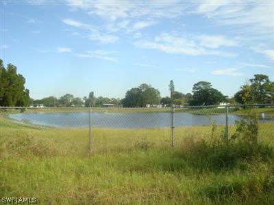 107 Oregon Road West Lehigh Acres, FL 33936 - Photo 2 of 10 a view of lake with green space