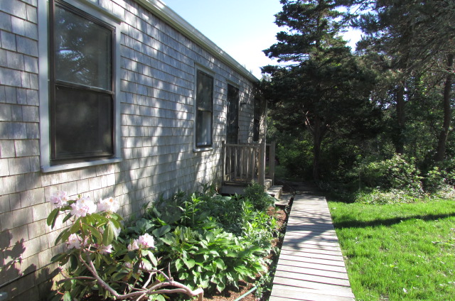 26 Miacomet Road Nantucket, MA 02554 - Photo 2 of 12 a view of a pathway with flower plants