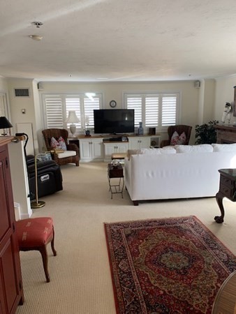 44 Elm Street, Unit 518 Worcester, MA 01609 - Photo 3 of 20 a living room with furniture and a flat screen tv