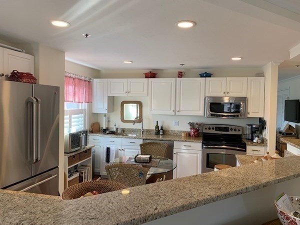 44 Elm Street, Unit 518 Worcester, MA 01609 - Photo 6 of 20 a kitchen with stainless steel appliances granite countertop a refrigerator stove microwave and sink
