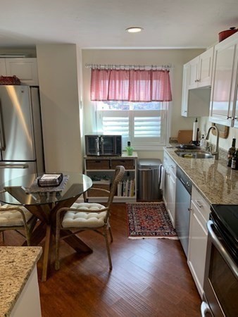 44 Elm Street, Unit 518 Worcester, MA 01609 - Photo 8 of 20 a kitchen with granite countertop a stove refrigerator and sink