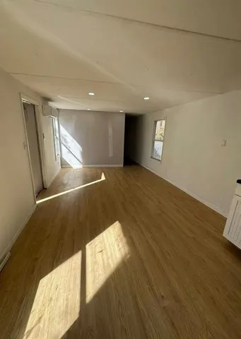 a view of an empty room and wooden floor