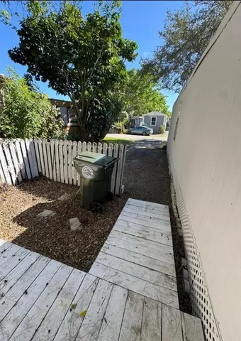 a view of a livingroom with furniture and a flat screen tv