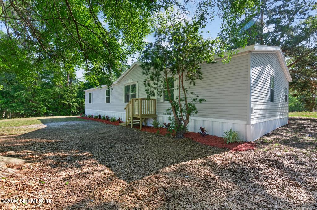216 Yucca Street Middleburg, FL 32068 - Photo 2 of 60 a view of a house with a yard and large tree