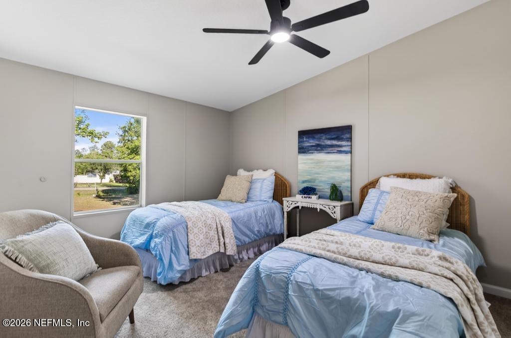 216 Yucca Street Middleburg, FL 32068 - Photo 39 of 60 a bedroom with two beds and a window