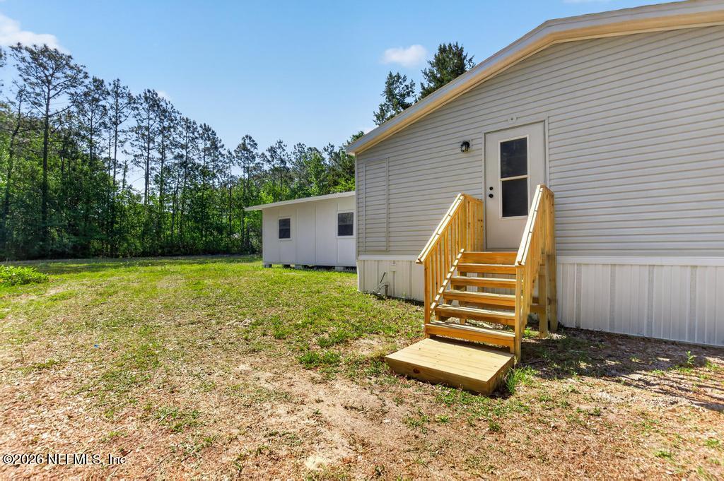 216 Yucca Street Middleburg, FL 32068 - Photo 46 of 60 a view of a house with backyard and garden