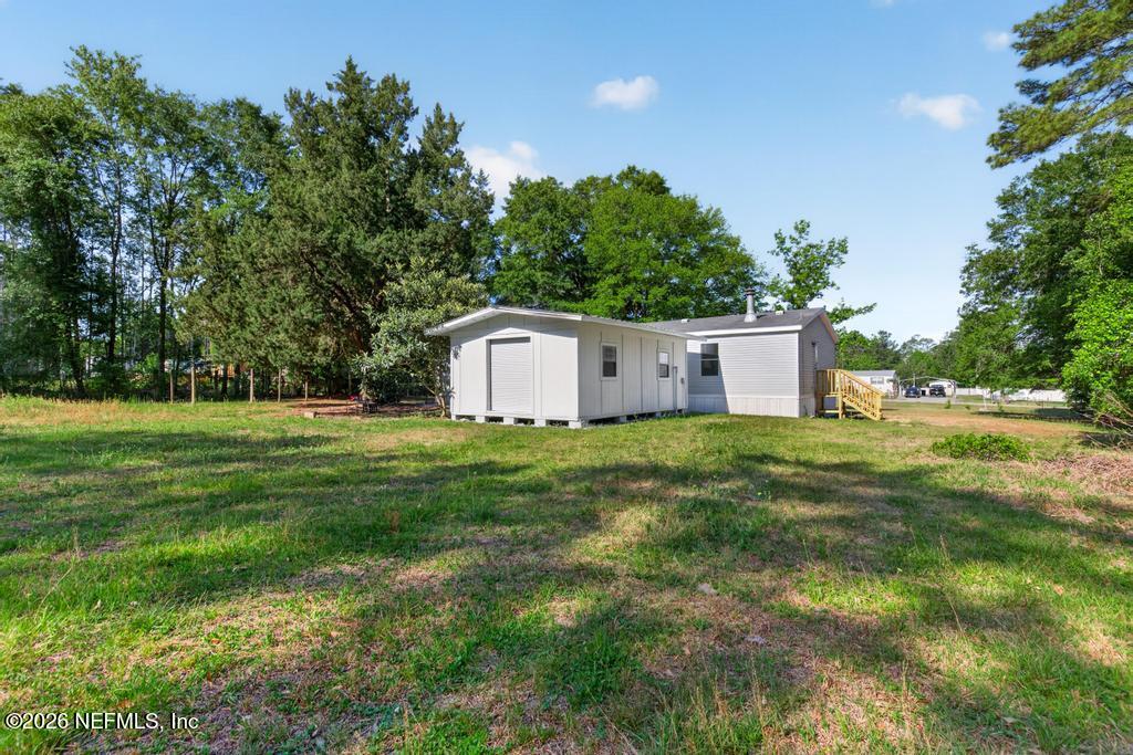 216 Yucca Street Middleburg, FL 32068 - Photo 47 of 60 a view of a house with backyard and trees