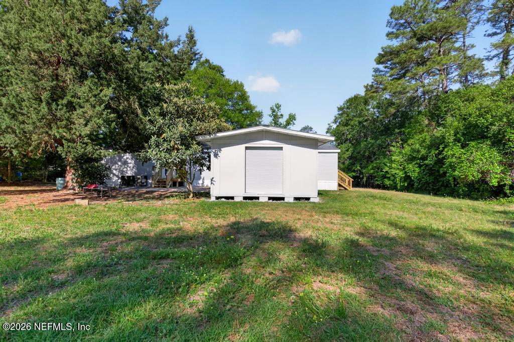 216 Yucca Street Middleburg, FL 32068 - Photo 50 of 60 a backyard of a house with lots of green space