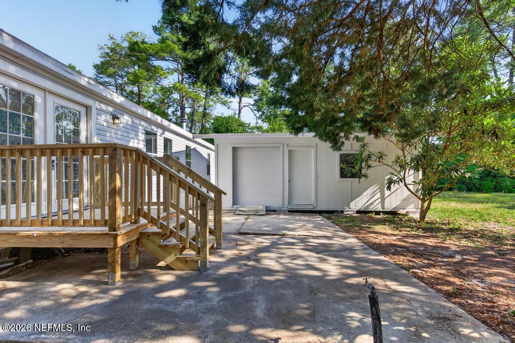 216 Yucca Street Middleburg, FL 32068 - Photo 52 of 60 a view of a house with a wooden deck and a trees