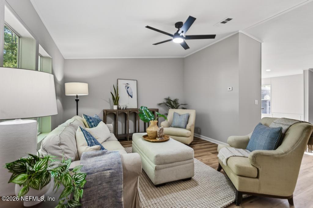 216 Yucca Street Middleburg, FL 32068 - Photo 7 of 60 a living room with furniture and a potted plant