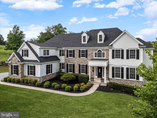 a front view of a house with a garden and plants