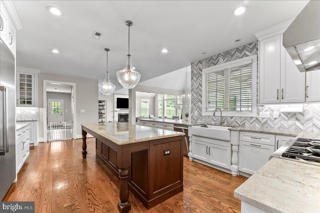 a bathroom with a sink toilet and window
