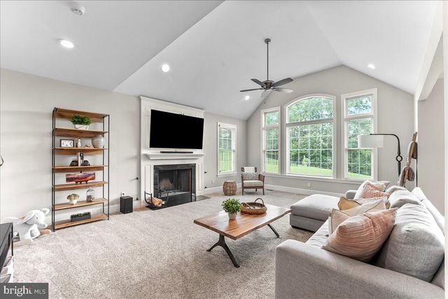 a view of a livingroom with workspace and a window