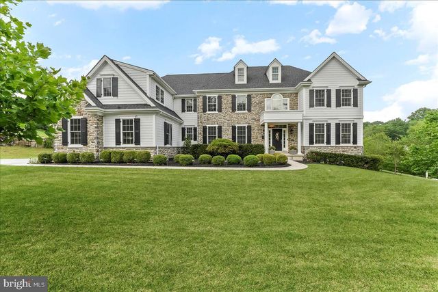 a front view of a house with a yard table and chairs
