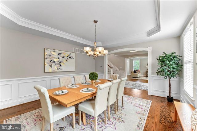 a large kitchen with kitchen island a dining table and chairs