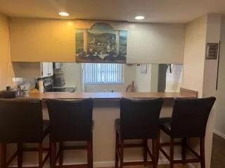 a kitchen with a table chairs sink and cabinets