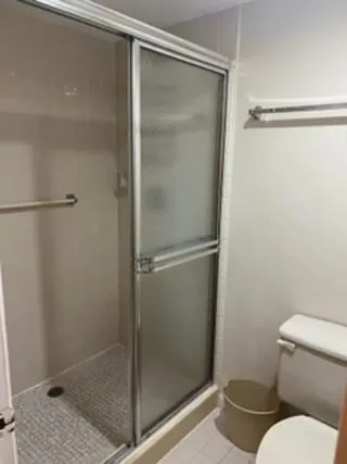 a bathroom with a glass shower door