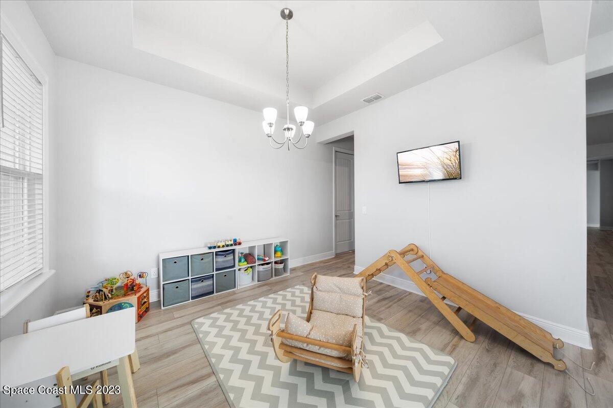 1582 Killian Drive Palm Bay, FL 32905 - Photo 12 of 37 a view of a room with furniture and wooden floor