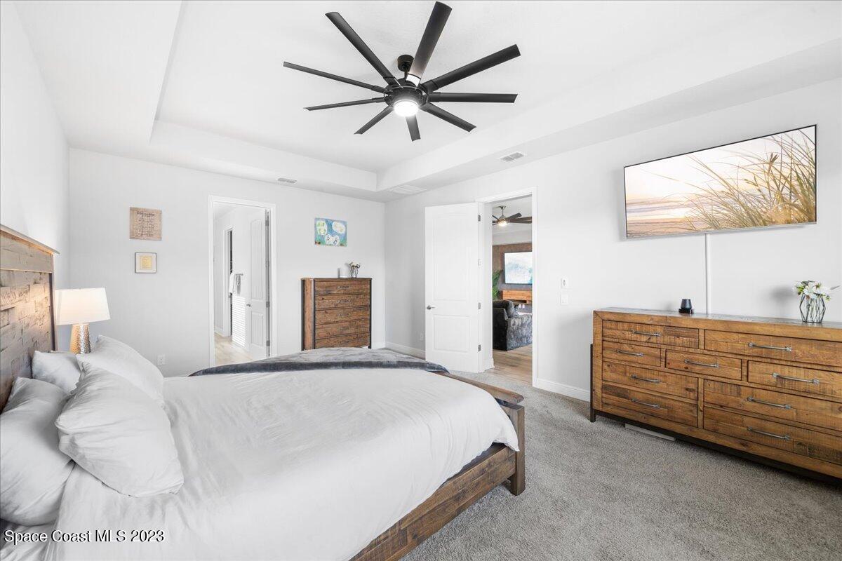 1582 Killian Drive Palm Bay, FL 32905 - Photo 16 of 37 a spacious bedroom with a bed and a large mirror