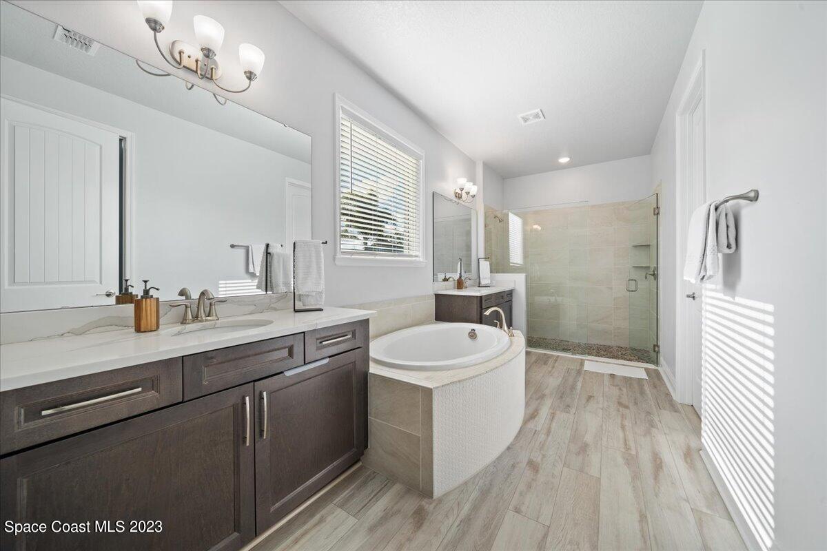 1582 Killian Drive Palm Bay, FL 32905 - Photo 19 of 37 a bathroom with a double vanity sink a mirror and a shower