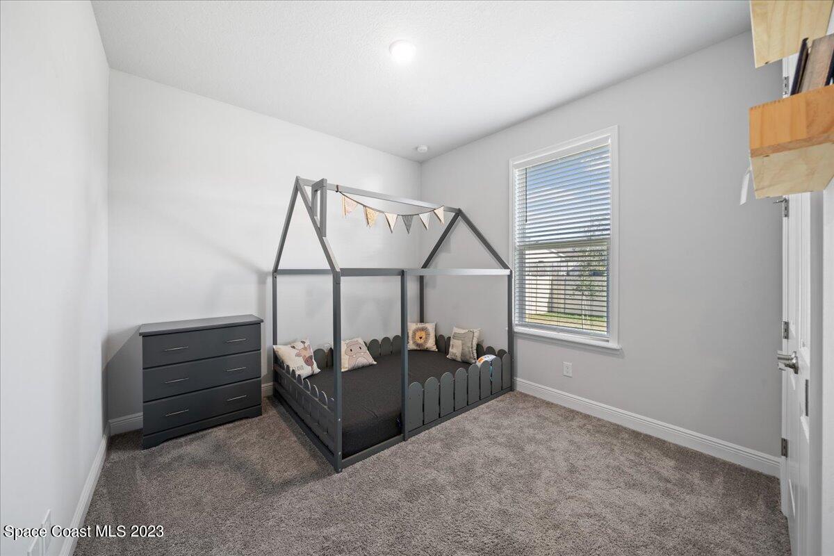 1582 Killian Drive Palm Bay, FL 32905 - Photo 20 of 37 a bed room with furniture and window