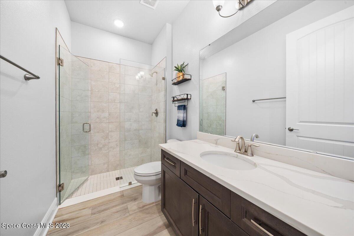 1582 Killian Drive Palm Bay, FL 32905 - Photo 22 of 37 a bathroom with a sink a toilet and shower