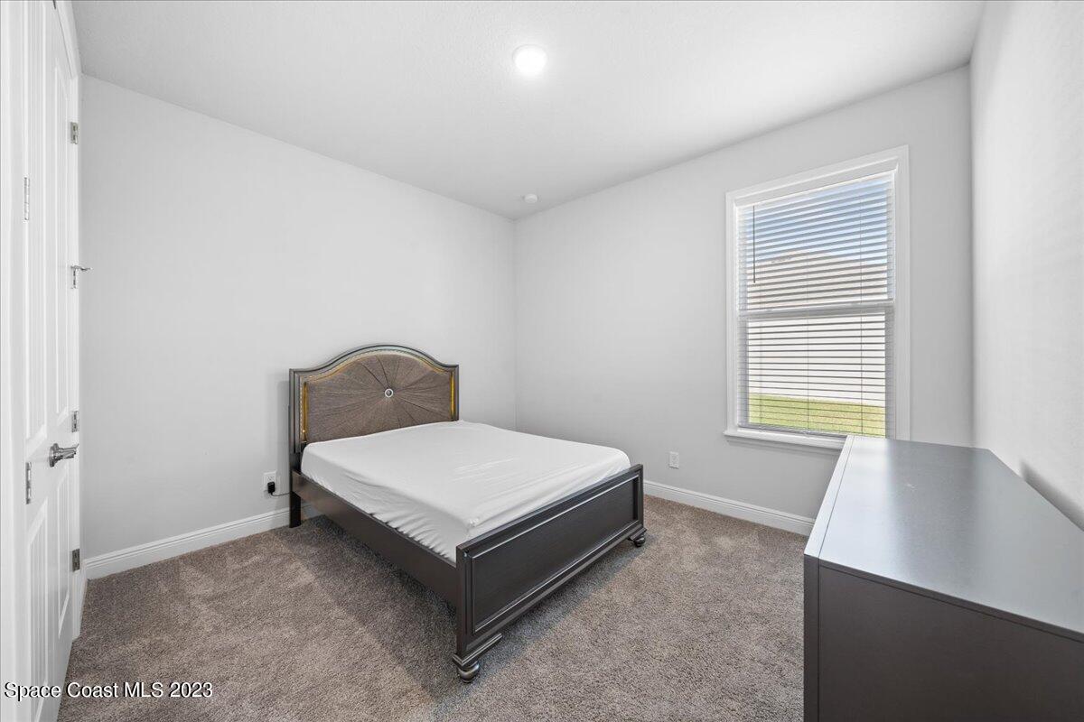 1582 Killian Drive Palm Bay, FL 32905 - Photo 23 of 37 a room with a bed and window