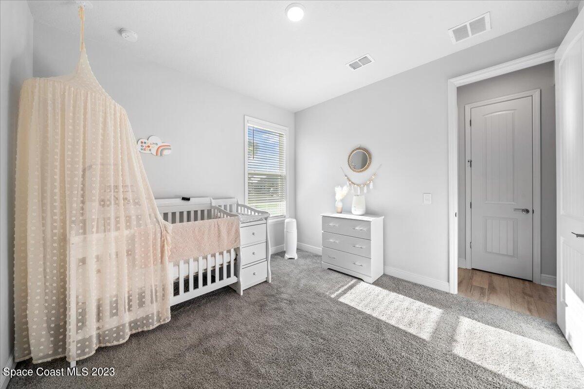 1582 Killian Drive Palm Bay, FL 32905 - Photo 25 of 37 a view of a bedroom with furniture and window