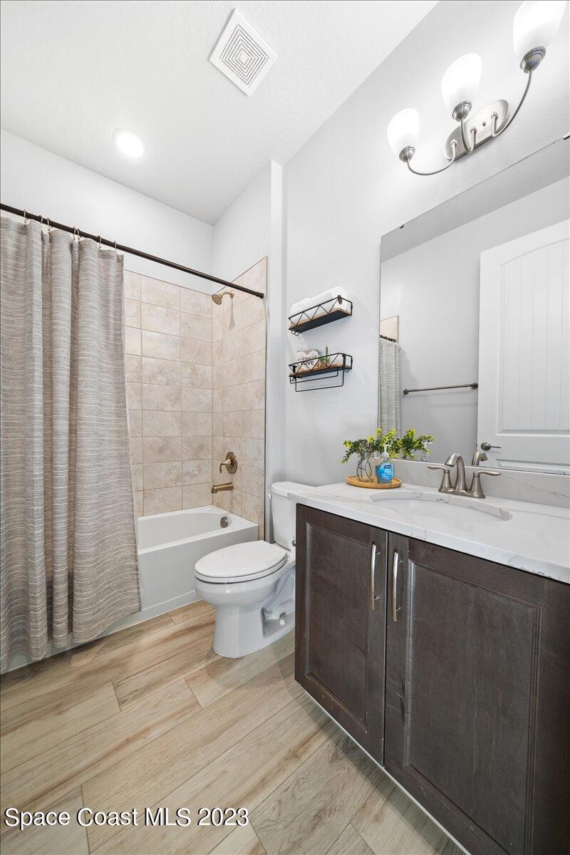 1582 Killian Drive Palm Bay, FL 32905 - Photo 27 of 37 a bathroom with a sink a toilet and shower