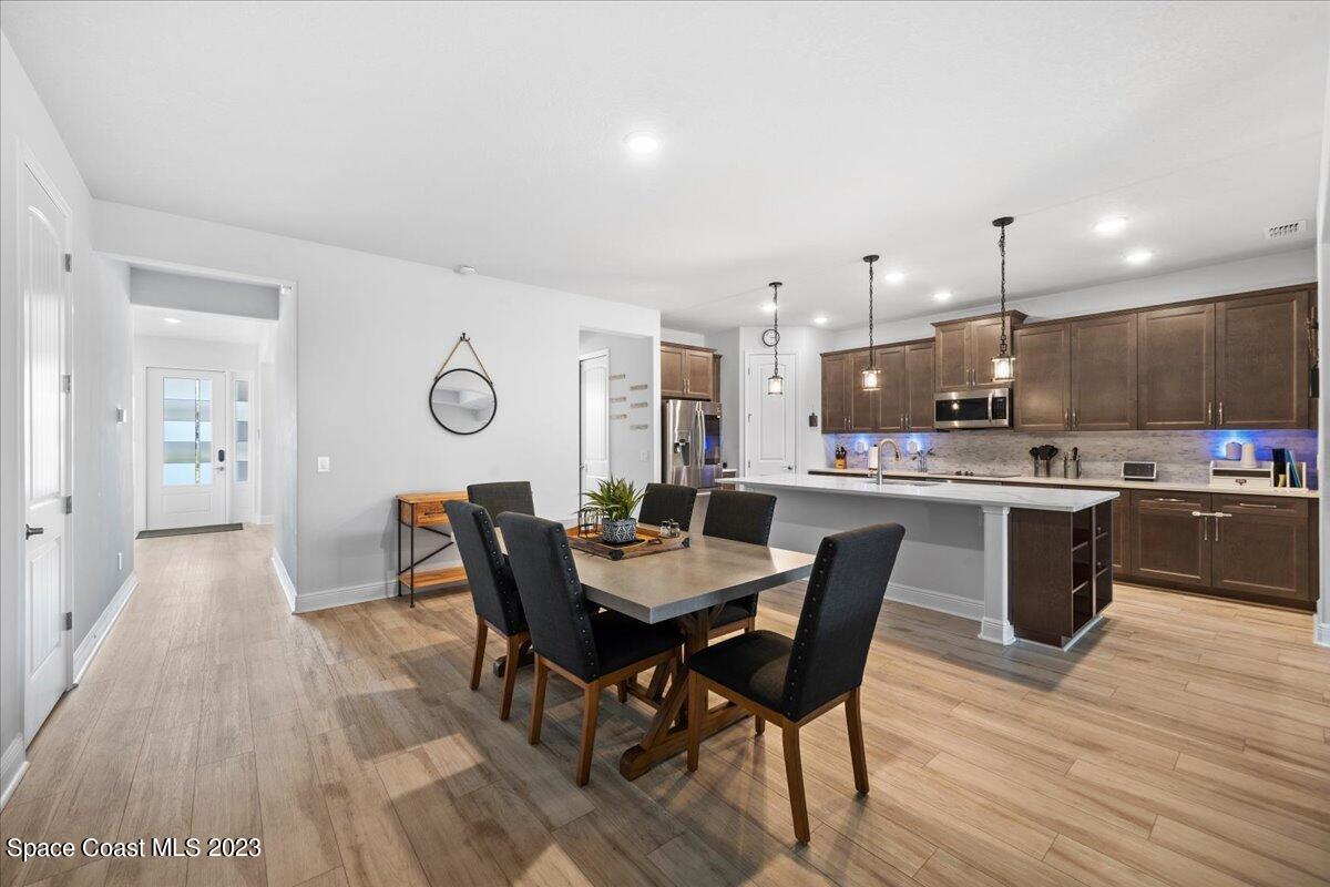 1582 Killian Drive Palm Bay, FL 32905 - Photo 3 of 37 a view of a dining room with furniture and wooden floor