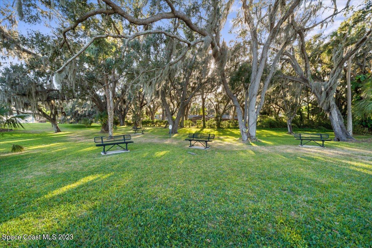 1582 Killian Drive Palm Bay, FL 32905 - Photo 35 of 37 a view of a park with trees and wooden fence
